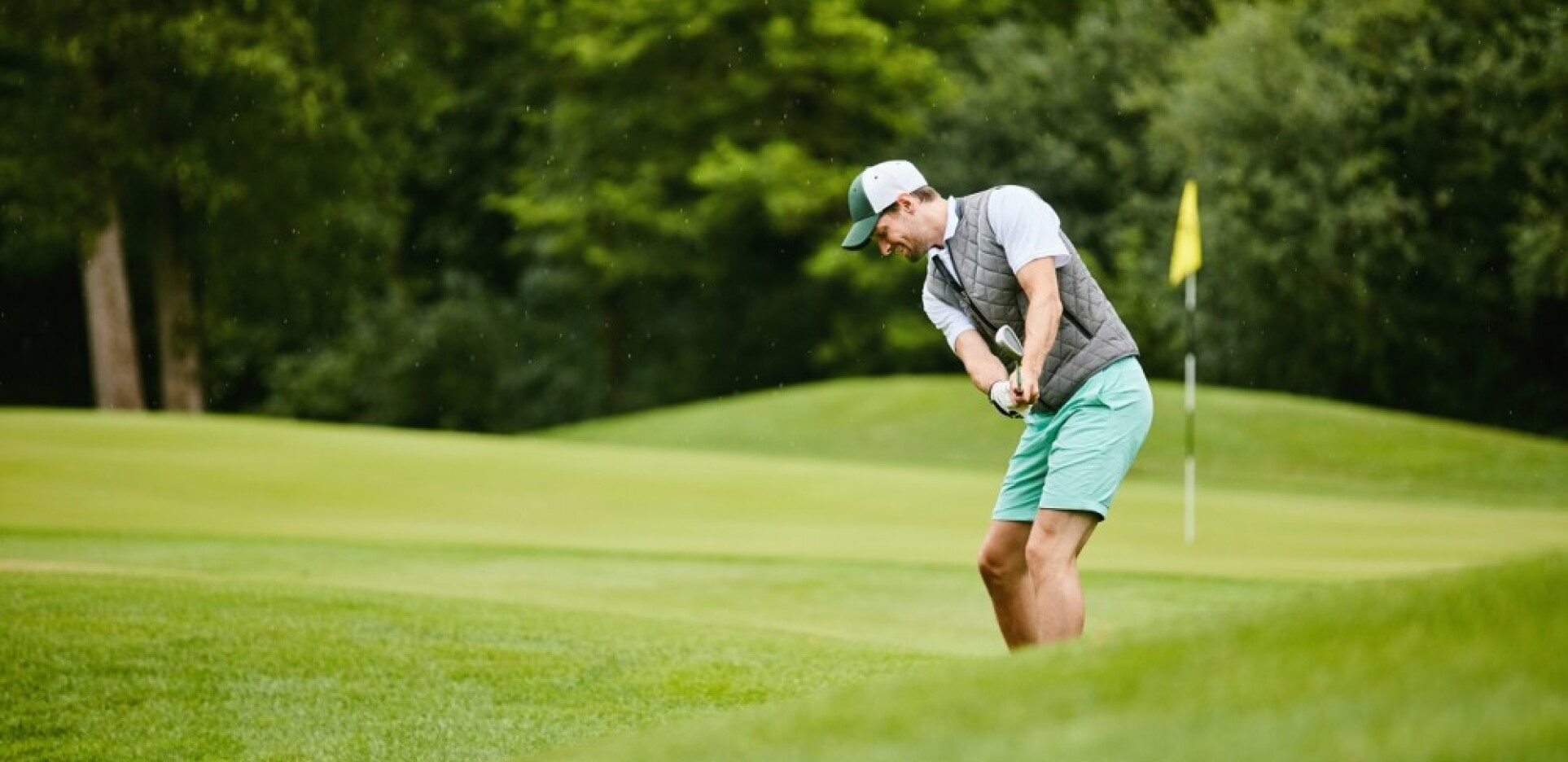 Image of golf ball on tee on grass.